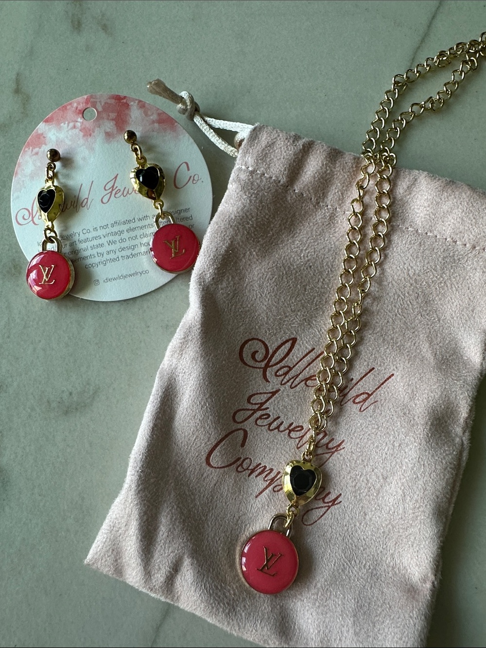 Gold-Tone Necklace and Earring Set with Pink LV charms and Black Heart Accents